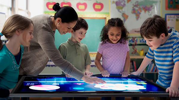 teacher and students with light table